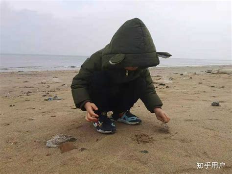 在海滩上拿着石头的小男孩高清图片下载-正版图片501524499-摄图网