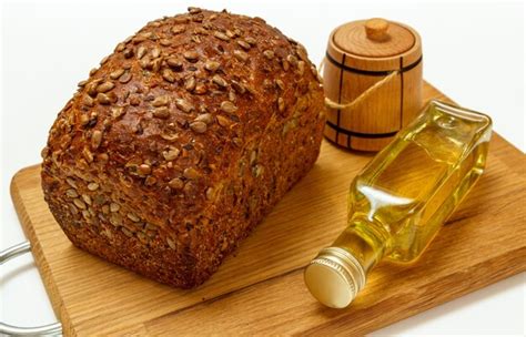Premium Photo | Loaf of rye bread, a bottle of sunflower oil and a ...