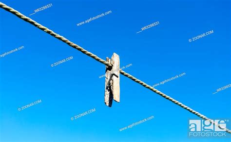 Old wooden clothespin on the rope against the blue sky, Stock Photo ...