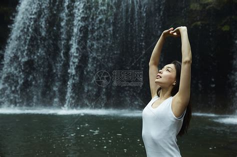 站在小溪边享受瀑布的女人在舒展身体高清图片下载-正版图片502071645-摄图网