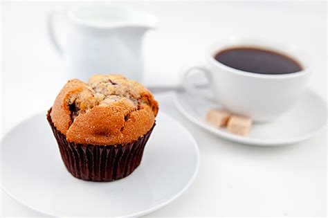 유토이미지 | Muffin and a cup of coffee on white plates with sugar and milk