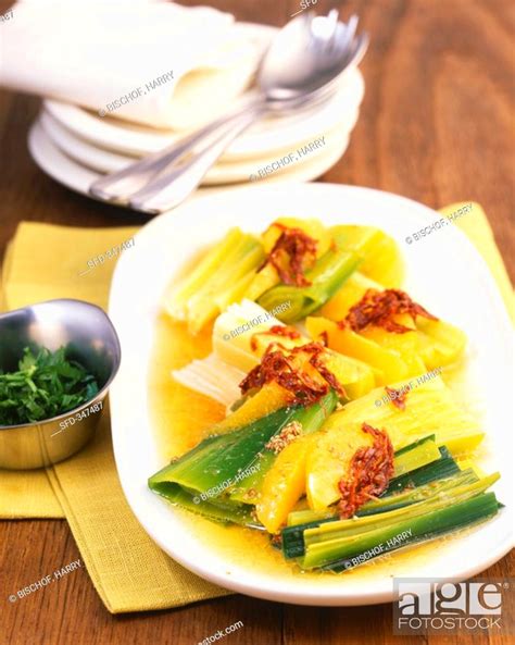Marinated leeks with oranges and dried tomatoes, Stock Photo, Picture ...