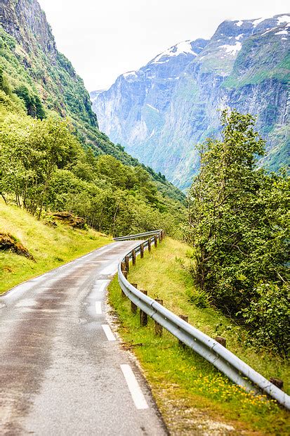 穿过夏季挪威山脉的道路阳光明媚的天气丽的绿色自然景观,背景中的森林挪威山区的道路高清图片下载-正版图片300880783-摄图网