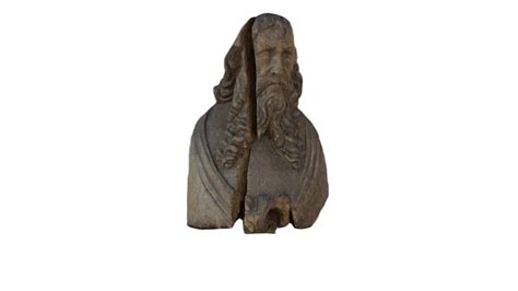 Una estatua de un hombre con barba y pelo largo. | Foto Premium