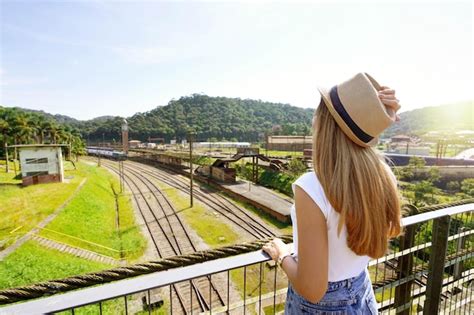 Premium Photo | Traveler girl looking the old train station with clock ...