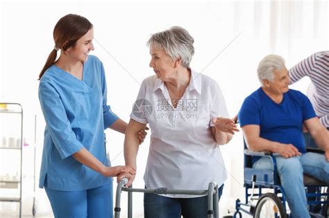 在养老院照顾残疾老年残疾妇女的年青高清图片下载-正版图片506170428-摄图网