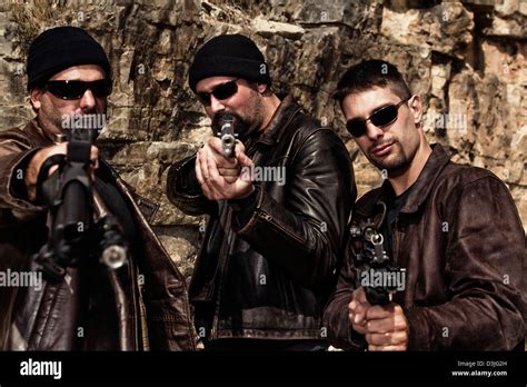 View of a group of gang members with guns Stock Photo - Alamy