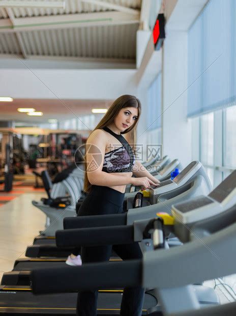 有吸引力的年轻体育女人正在健身房锻炼在曲线跑步机上进行有氧训练在非电动高清图片下载-正版图片505857829-摄图网