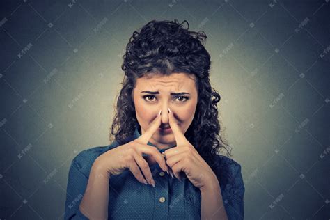 女人捏鼻子的手指看起来令人厌恶的东西臭难闻的气味高清摄影大图-千库网