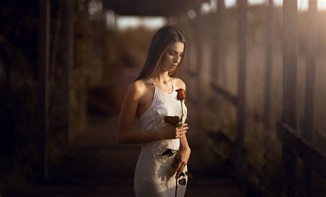 Download Mature Woman Holding A Rose Wallpaper | Wallpapers.com