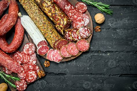 Different types of salami on wooden Board. 32010548 Stock Photo at Vecteezy