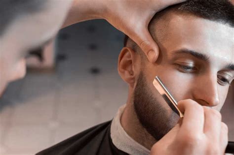 理发店的主人刮胡子,割镜子前的人高清图片下载-正版图片300166982-摄图网