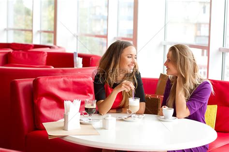 两个女孩在自助餐厅喝咖啡乐趣朋友们杯子成人女孩们团体讲话微笑餐厅友谊高清图片下载-正版图片321811216-摄图网