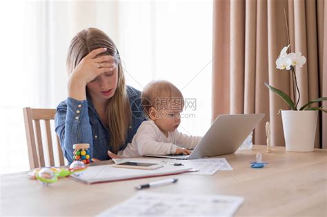 工作母亲在腿上怀着孩子疲劳累高清图片下载-正版图片503496895-摄图网