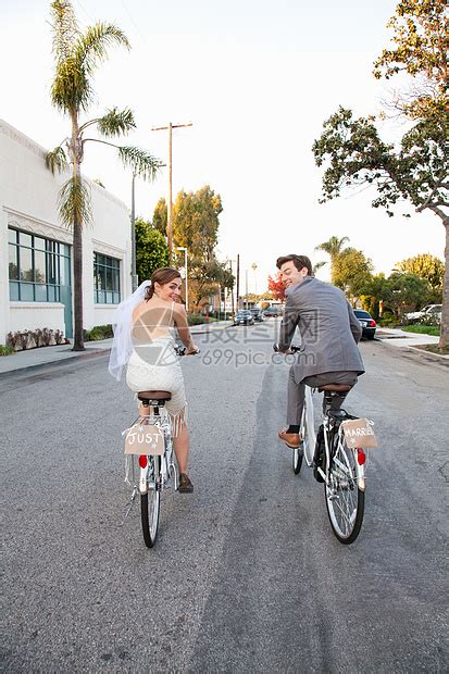 年轻的新婚夫妇沿着街道骑车，后视镜高清图片下载-正版图片501509611-摄图网