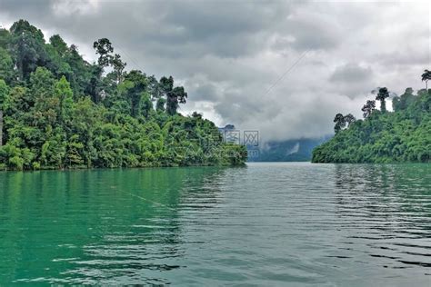 翠绿的湖水很平静小岛有一片绿色的热带森林远处的山脉隐藏在低矮的云层后面高清图片下载-正版图片506714926-摄图网