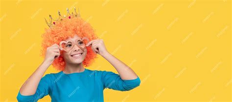 Premium Photo | Happy funny kid in curly wig and crown imagine herself ...