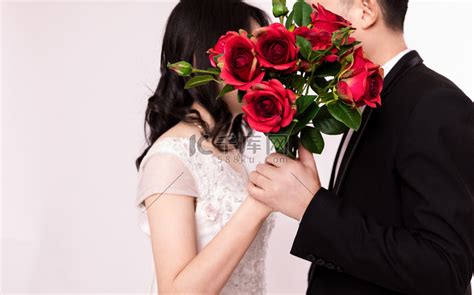 情人节七夕手拿玫瑰花的情侣求婚爱情摄影图配图高清摄影大图-千库网