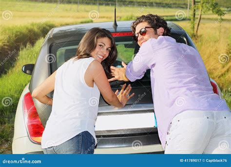 Smiling And Funny Couple Pushing A Car Stock Photo - Image: 41789017