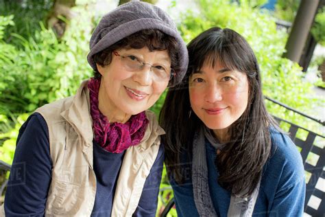 Portrait of smiling older Japanese mother and daughter - Stock Photo ...