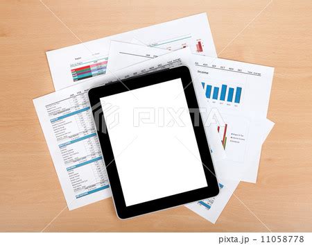 Tablet with blank screen over papers with...の写真素材 [11058778] - PIXTA