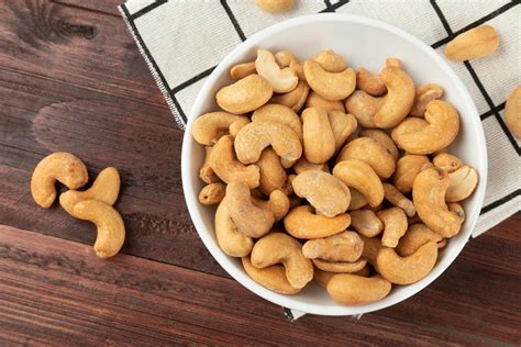 Cashew nuts in white bowl on the table, Healthy snack, Vegetarian food ...