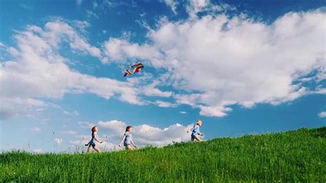 无忧无虑的孩子们拿着风筝沿着绿色的小山奔跑视频素材_ID:VCG42N829409822-VCG.COM