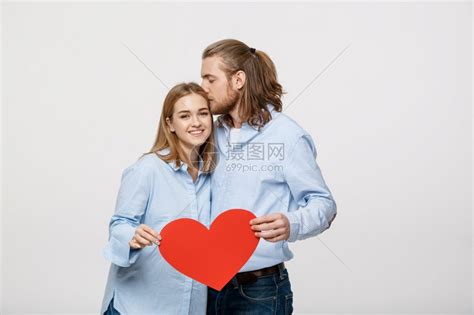 丈夫拿着红心亲吻妻子 高清图片下载-正版图片303662910-摄图网