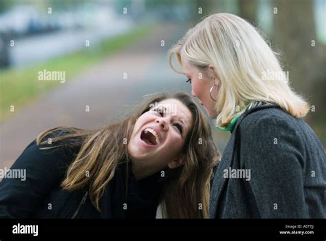 two caucasian teenage girls fight violently. One girl screams with ...